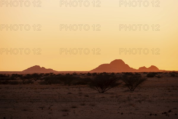 Silhouette of mountains with sunset sky in the lonely desert of Spitzkoppe, Spitzkoppe, Namibia