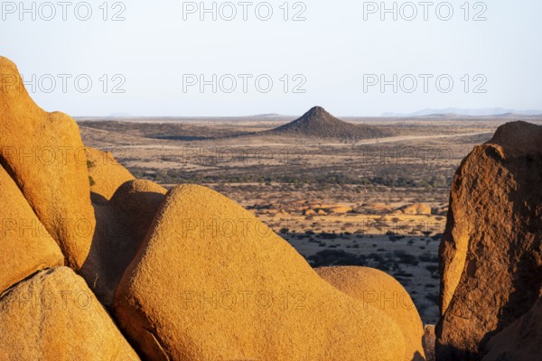 Impressive rock formations offer a wide view of the dry desert plain of Spitzkoppe, Spitzkoppe, Namibia
