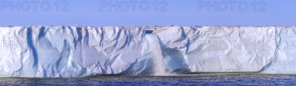 Waterfall at edge of Brasvellbreen glacier from the ice cap Austfonna pouring fresh water into the Barents Sea, Nordaustlandet, Svalbard / Spitsbergen
