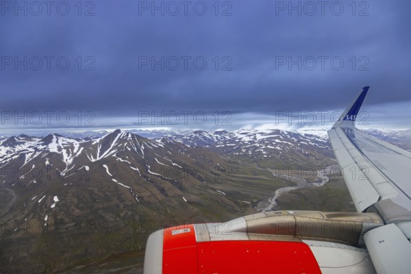 Airplane wing and aerial view over Adventdalen in summer, 30-kilometre valley and river Adventdalselva on the island Spitsbergen in Svalbard, Norway