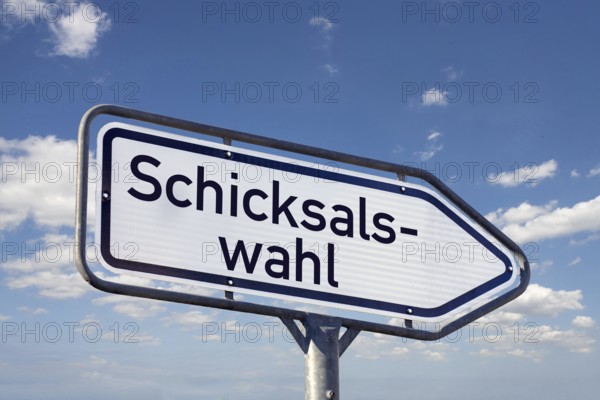 (Photomontage) Directional arrow with the inscription CHOICE of FATE against a blue sky