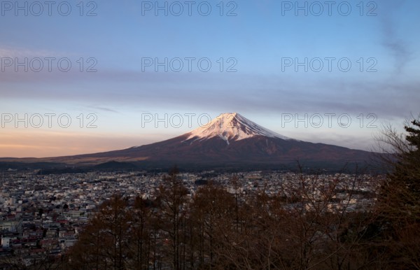 View of Mount Fuji volcano over Fujiyoshida City, at sunrise, Arakurayama Sengen Park, Yamanashi Prefecture, Japan