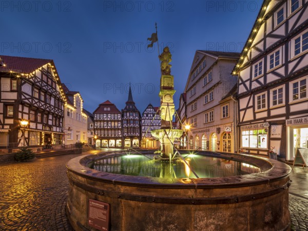 Market square with Roland fountain, cobblestones and half-timbered houses in the historic old town in the evening, Fritzlar, Hesse, Germany