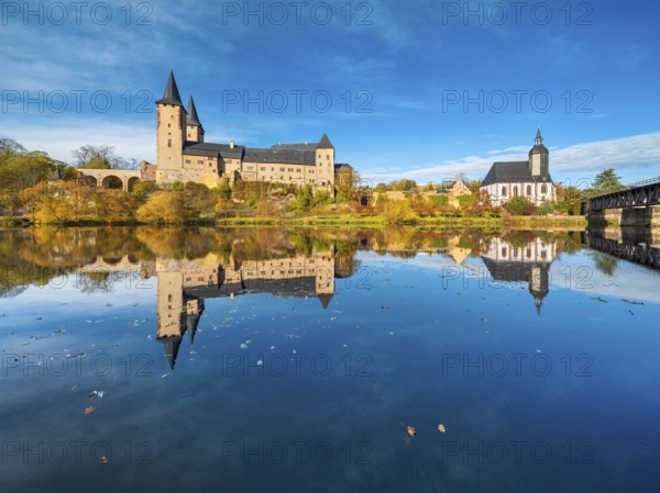 Rochlitz Castle and St. Peter's Church in autumn, perfect reflection in the Zwickauer Mulde river, Rochlitz, Saxony, Germany