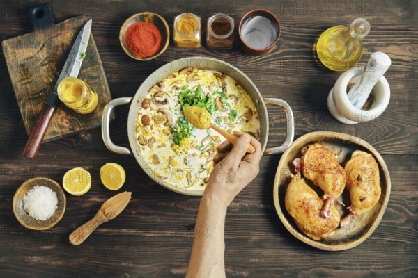 A person adds cardamon into pan with chopped mushrooms, onion, herbs and cream. Adding flavour to creamy mustard sauce