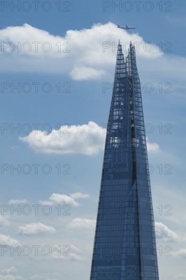View from the Sky Garden of the modern glass skyscraper The Shard over which an airplane flies, London, England, Great Britain