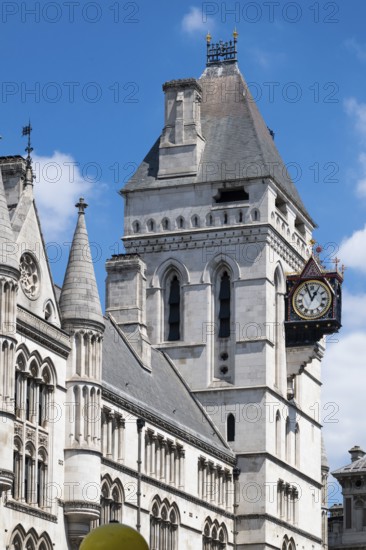 Royal Courts of Justice, neo-gothic architecture with tower and clock under blue sky, London, England, Great Britain