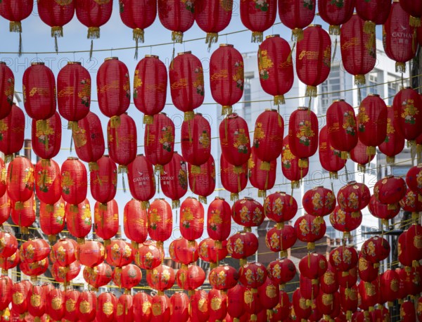 Red Chinese lanterns hang close together under the open sky, London, England, Great Britain