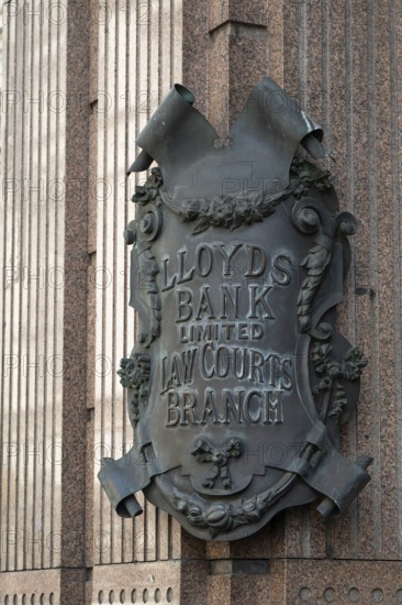 Lloyds Bank coat of arms like metal sign in decorative style on stone wall, London, England, Great Britain