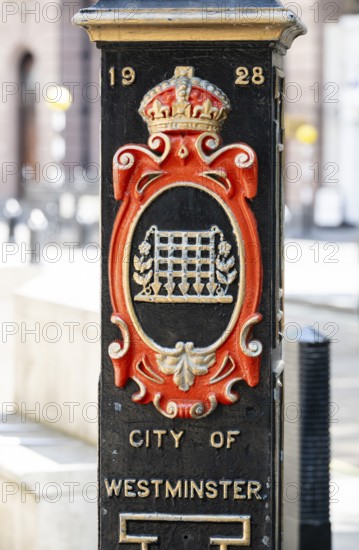 Decorative column with date 1928 marks border with the City of Westminster with coat of arms and crown, London, England, Great Britain