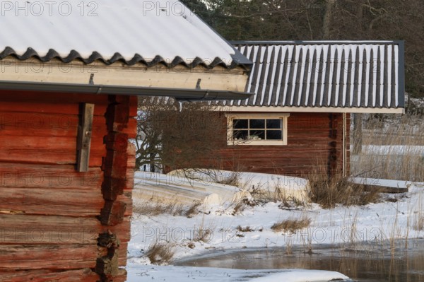 Snowy wooden huts in a winter landscape, Korpoström, Korpo or Korppo, southwestern archipelago, Finland