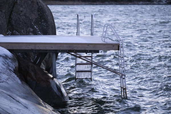 Jetty on a wintry coast with waves and icicles on a staircase, Korpoström, Korpo or Korppo, southwestern archipelago, Finland