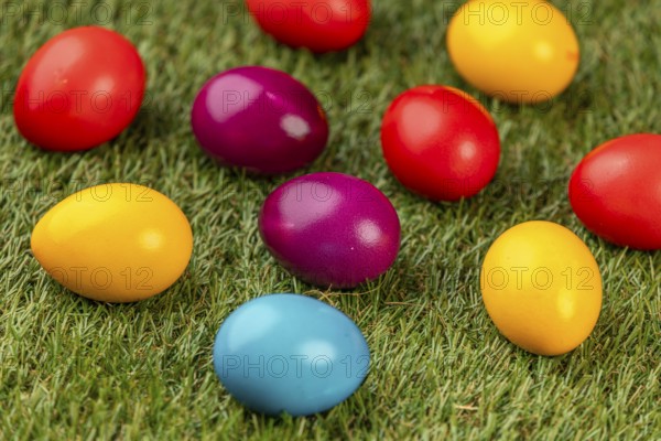 Colourful Easter eggs spread on green grass
