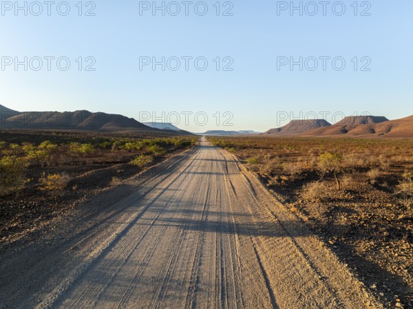 Beautiful dirt road through dry desert landscape, hills in Damaraland, Namibia