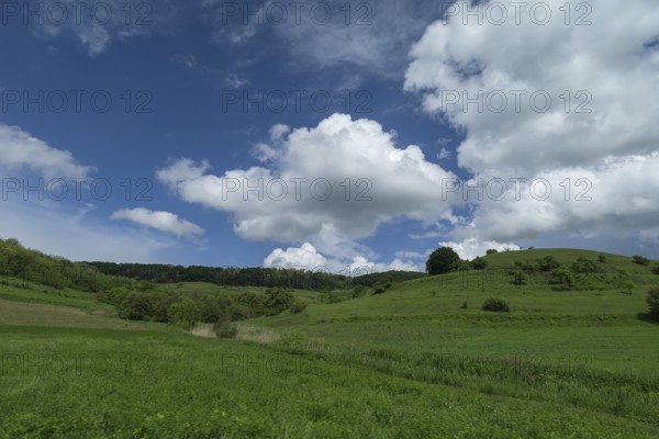 Cluster clouds (cumulus) over the landscape in the southern Carpathian Arc, Romania