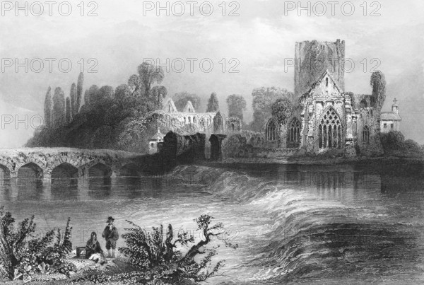 Ruin of Holycross Abbey Church, former Cistercian monastery, Holycross Village, County Tipperary, Ireland, quiet atmosphere, cataract, old stone bridge, monastery complex, nave, people on the shore, group of trees, architecture, religion, landmark, steel engraving, 19th century, historical illustration from 1845