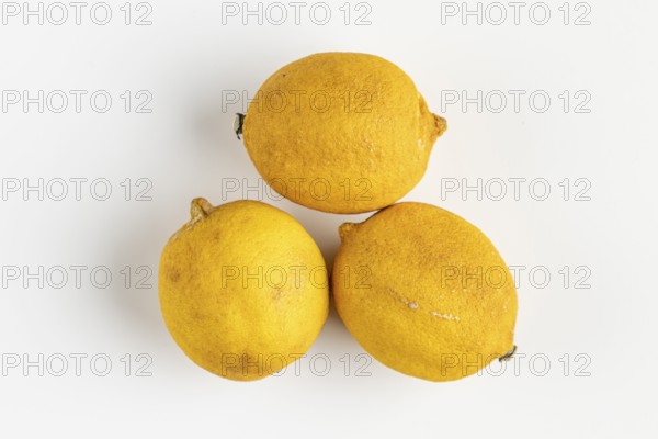 Three old lemons on a light background