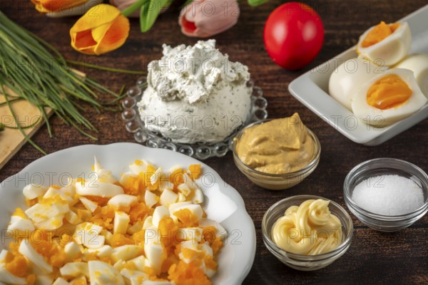 Ingredients for egg cream, such as cream cheese, sliced eggs and herbs