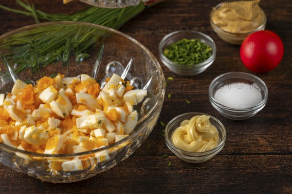 Ingredients arranged in trays for egg cream on a wooden table