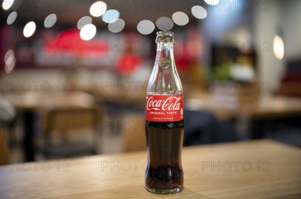 Coke, Coca-Cola, bottle, 0.3 liter, half full, half empty, standing on a table, restaurant, bar, Stuttgart, Baden-Württemberg, Germany