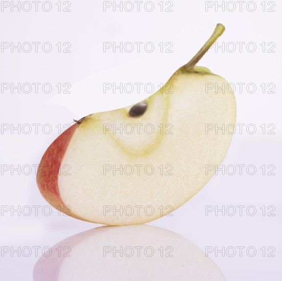 Apple cleft (Malus domestica) in front of a white background, studio shot
