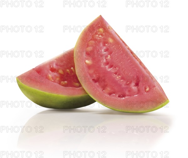 Two quarters of a sliced guava (Psidium guajava) in front of a white background, studio photo