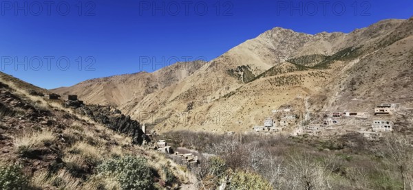 Panorama of a rural settlement in a barren mountain landscape, Atlas Mountains, Morocco