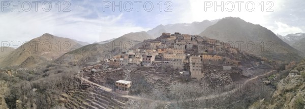 A panorama of a rocky village on a plateau under a cloudy sky, Morocco