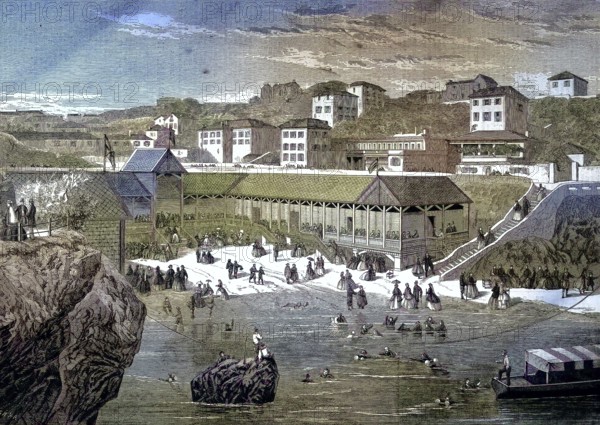 A summer morning at Biarritz beach, France, beach and swimming people, promenade walkers/A summer morning at Biarritz beach, France, beach and swimming people, promenade, historical, digitally restored reproduction of an original original from the 19th century, exact original date unknown, colored later