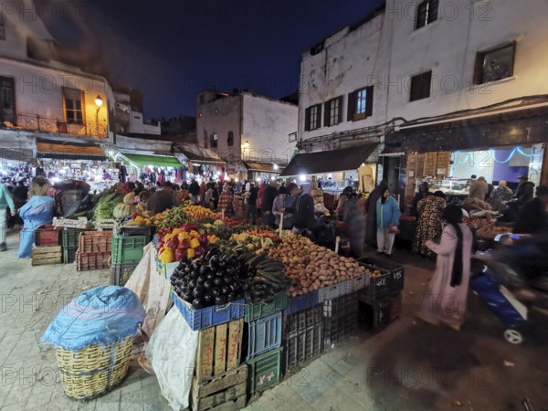 Hustle and bustle night market, lots of people and colorful stalls full of fresh produce in the medina of Casablanca, Morocco