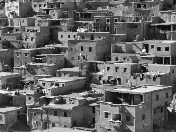 Dense collection of old, winding buildings in an oriental settlement, black and white photo, Morocco
