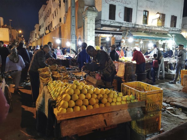Colourful night market with numerous stalls, illuminated with the hustle and bustle of people in the Medina of Casablanca, Morocco
