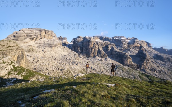 Hikers on the Grosté Plateau, mountain peaks of the Brenta Mountains, Brenta, Brenta-Adamello Natural Park, Trentino, Italy