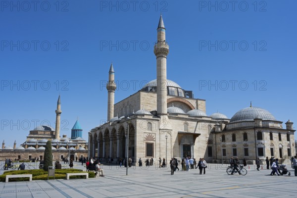 Historic mosque with several minarets under clear blue sky, people gathered in the square, Mevlânâ Museum, Mevlana, landmark, mausoleum of Mevlânâ Jalal ad-Din Rumi, Konya Sultan Selim Camii, Konya, Central Anatolia, Turkey