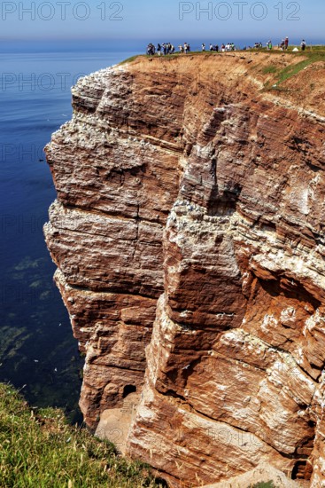 Red cliffs under a clear sky with the blue sea, the high-seas island of Heligoland in the North Sea