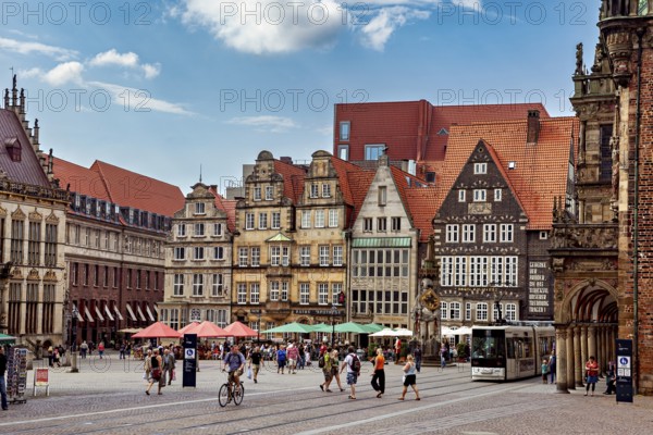 Lively historic old town with half-timbered houses and a tram against a clear blue sky, the center of the Hanseatic City of Bremen