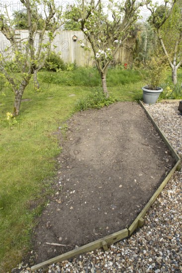 Garden border ready to be sown with wildflowers in spring, England, United Kingdom