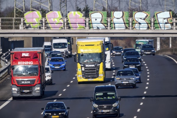 A57 motorway near Kaarst in the Rhein-Kreis Neuss, view towards Kaarst motorway junction, direction Cologne, heavy traffic, sign bridge with graffiti, North Rhine-Westphalia, Germany