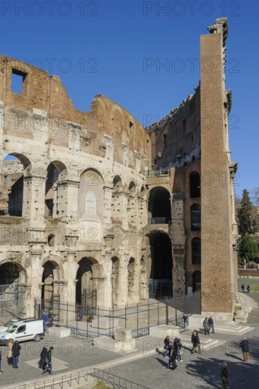 Partial view of the Colosseum Anfiteatro Flavio Amphitheatrum Flavium in modern times today with outer wall built on the right at the time of Emperor Domitian with fourth floor from year 81 AD, on the left three-storey three-storey building condition from 80 AD as in the time of Emperor Titus, Rome, Lazio, Italy