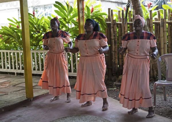 Guatemalan woman in traditional clothing singing and dancing, Garifuna people, Livingston, Izabal Department, Guatemala