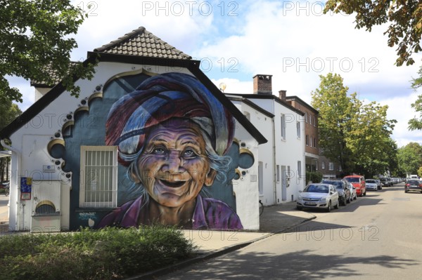 Graffiti portrait of an elderly woman from Bali. The work of art is part of the Kultur aus Tausch project. The aim of this initiative is to bring portraits of different cultures around the world to the streets of Oldenburg, Lower Saxony, Germany