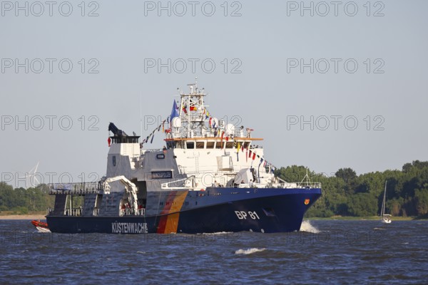 Decorated ship of the German Coast Guard and Federal Police BP 81 Potsdam leaves the Port of Hamburg on the Elbe after Hamburg's port birthday, Wedel, Schleswig-Holstein, Germany