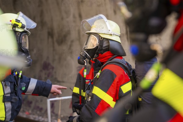 Firefighters talking, equipped with respiratory protection and protective equipment, in a tunnel, fire brigade exercise on the Hermann Hesse Railway, Ostelsheim, Calw district, Germany
