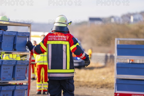 A firefighter in uniformed clothing stands on a railway line with equipment, fire department practice at the Hermann Hesse Railway, Ostelsheim, Calw district, Germany