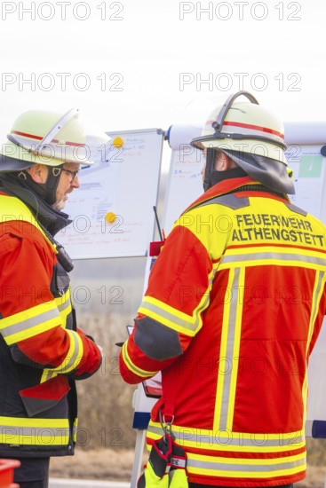 Firefighters at an outdoor briefing, analyzing plans and coordinating strategies, fire brigade exercise at the Hermann Hesse Railway, Ostelsheim, Calw district, Germany
