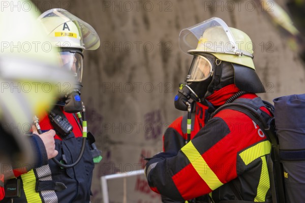 Two firefighters wearing respirators talking, ready for deployment in a tunnel, fire brigade exercise on the Hermann Hesse Railway, Ostelsheim, Calw district, Germany