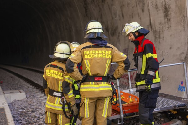 Fire team wearing protective clothing during a rescue operation in a railway tunnel, fire brigade exercise on the Hermann Hesse Railway, Ostelsheim, Calw district, Germany