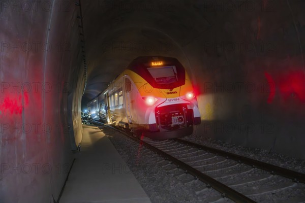 Modern train passes through illuminated tunnel breaking through darkness, fire brigade exercise on the Hermann Hesse Railway, Ostelsheim, Calw district, Germany
