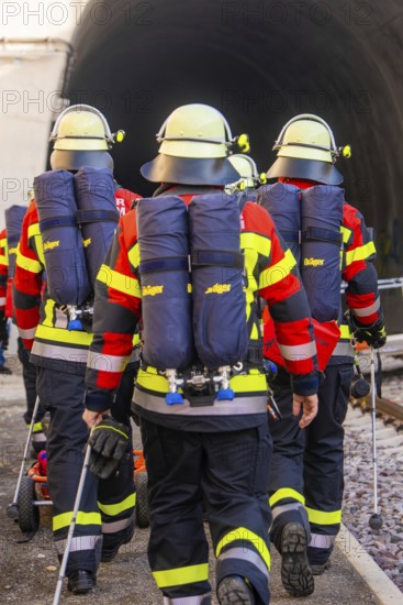 Firefighters in protective clothing and equipment on their way into a tunnel, fire brigade exercise at the Hermann Hesse Railway, Ostelsheim, Calw district, Germany