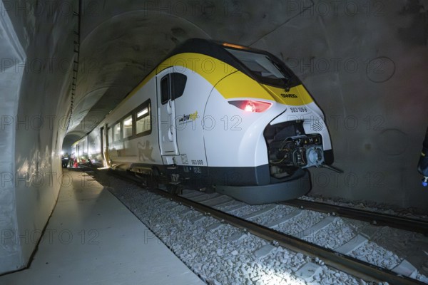 A yellow and white train goes through a gloomy tunnel, fire department exercise on the Hermann Hesse Railway, Ostelsheim, Germany